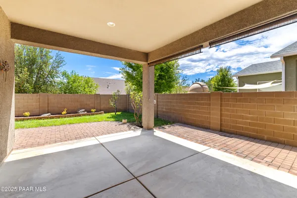 a view of a backyard with wooden fence