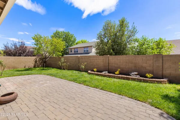 a view of house with backyard and garden