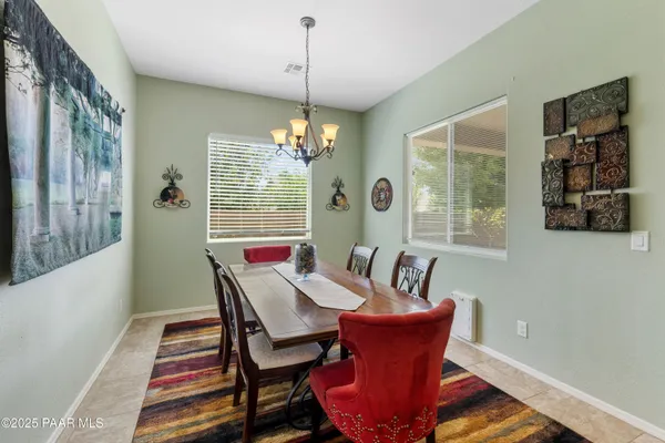 a view of a dining room with furniture wooden floor and a chandelier