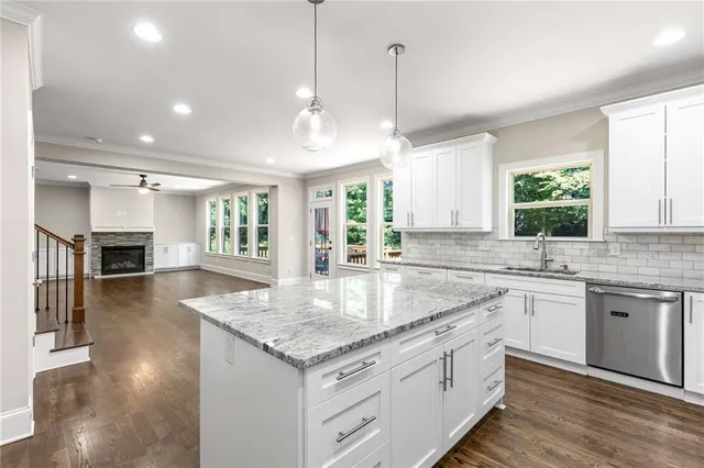 a view of a livingroom with a fireplace wooden floor and windows