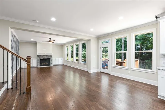 a living room with furniture and a view of kitchen