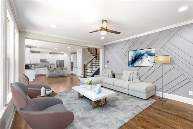 a view of an empty room with wooden floor fireplace and a window
