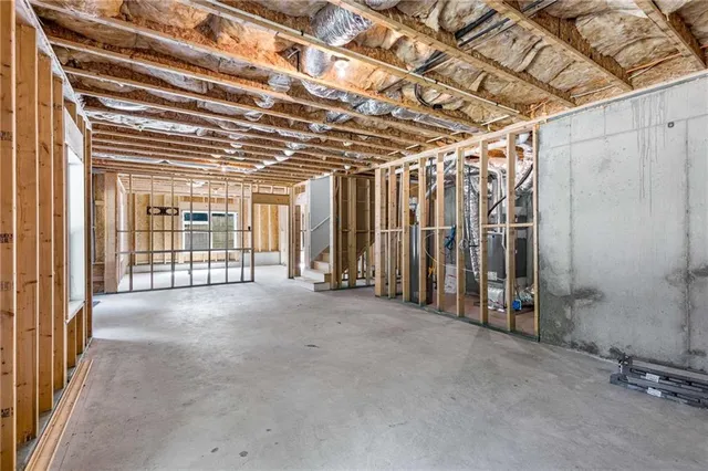 an aerial view of residential houses with outdoor space and trees