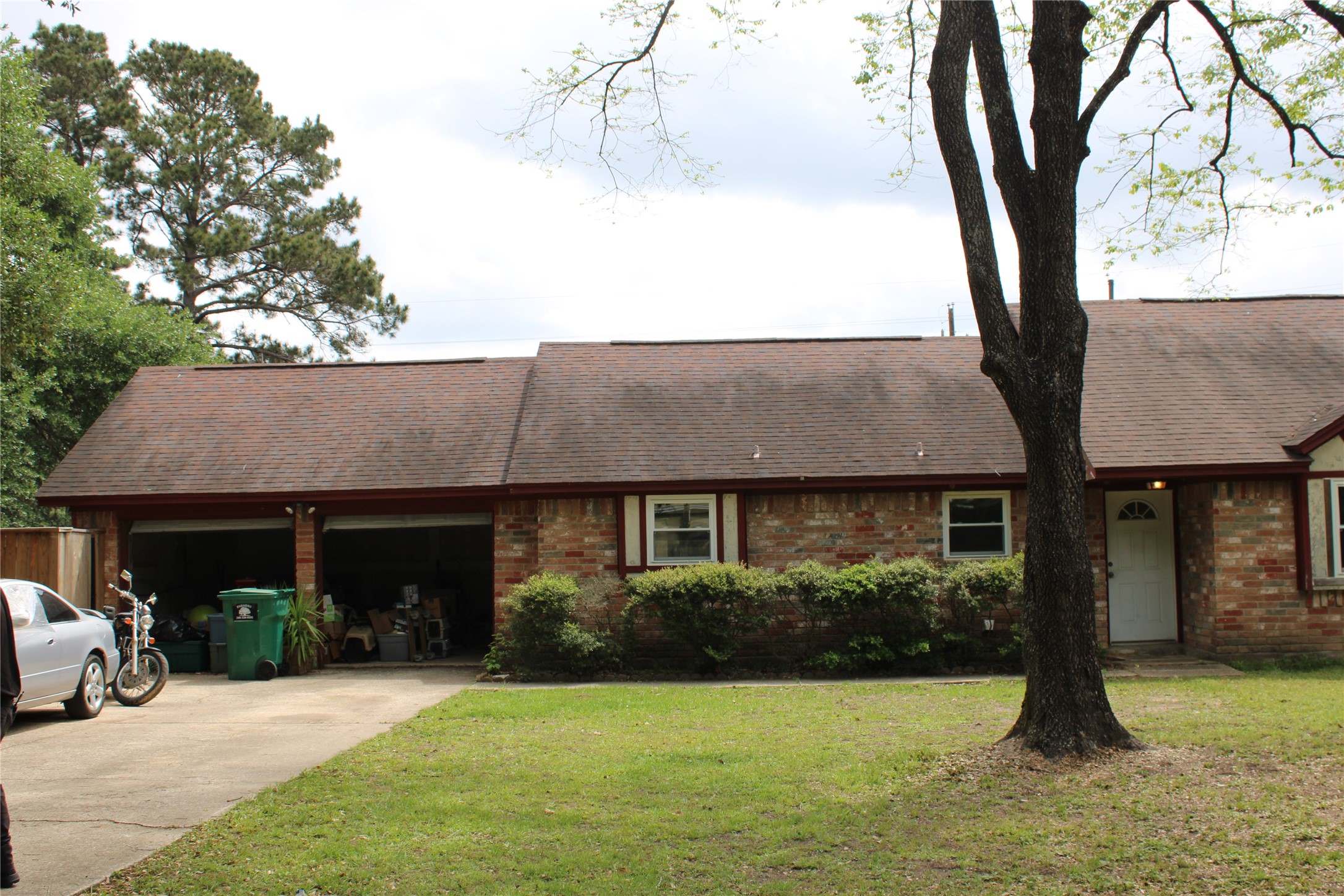 32056 South Wiggins Street Magnolia, TX 77355 - Photo 2 of 6 a front view of a house with a yard garage and outdoor seating