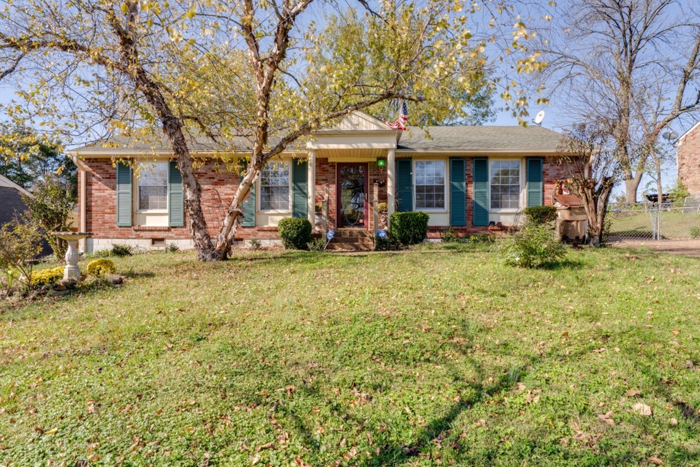 413 Gates Road Goodlettsville, TN 37072 - Photo 1 of 3 a front view of a house with a garden and trees