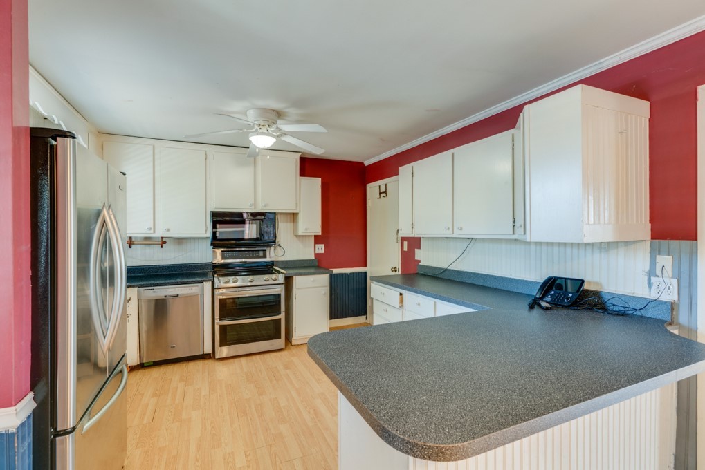 413 Gates Road Goodlettsville, TN 37072 - Photo 2 of 3 a kitchen with stainless steel appliances granite countertop a sink dishwasher stove top oven and refrigerator with wooden floor