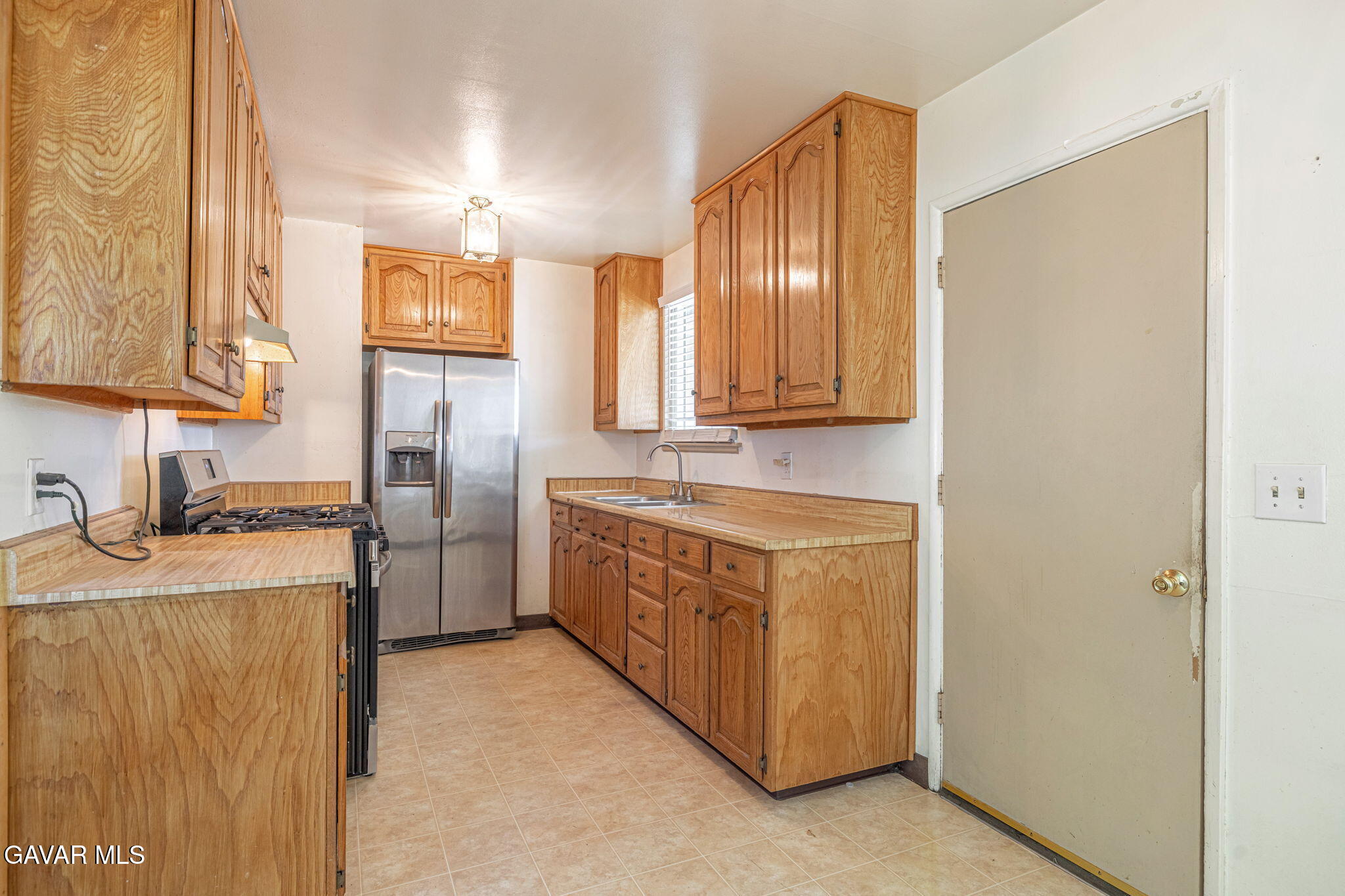 45309 Newtree Avenue Lancaster, CA 93534 - Photo 13 of 35 a kitchen with stainless steel appliances granite countertop a sink stove and refrigerator