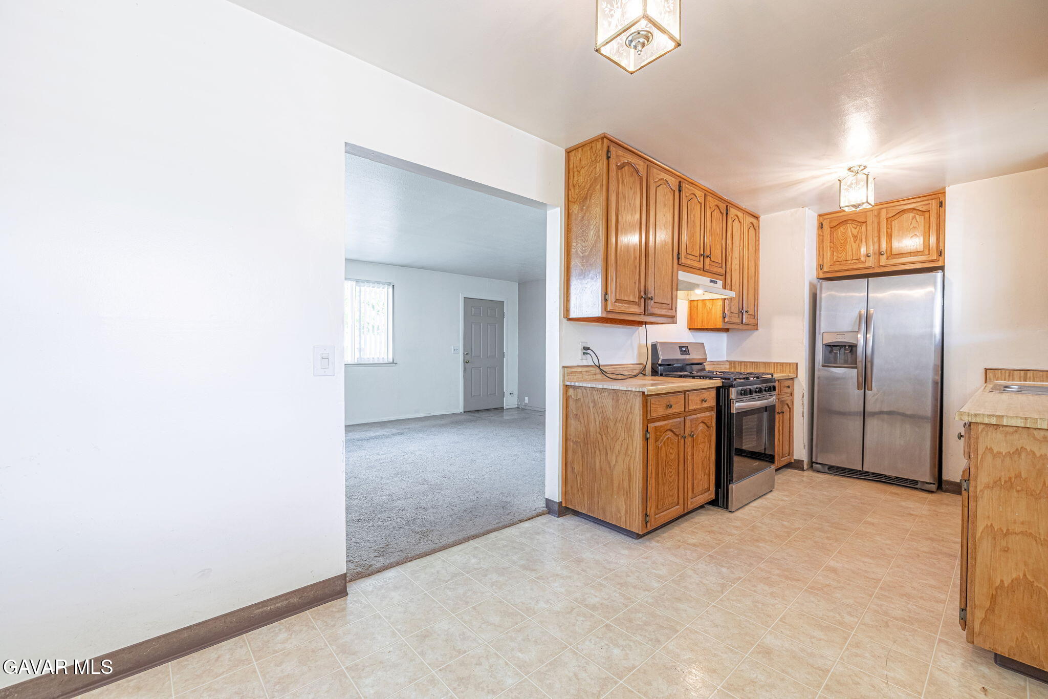 45309 Newtree Avenue Lancaster, CA 93534 - Photo 17 of 35 a kitchen with a refrigerator and a sink