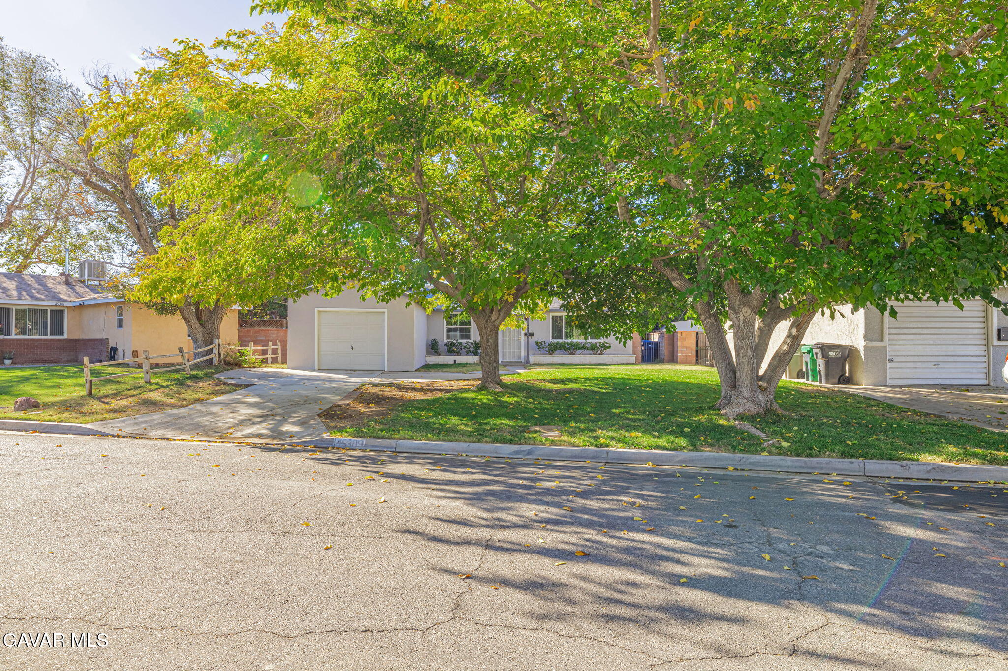 45309 Newtree Avenue Lancaster, CA 93534 - Photo 3 of 35 a front view of a house with a yard and a garage