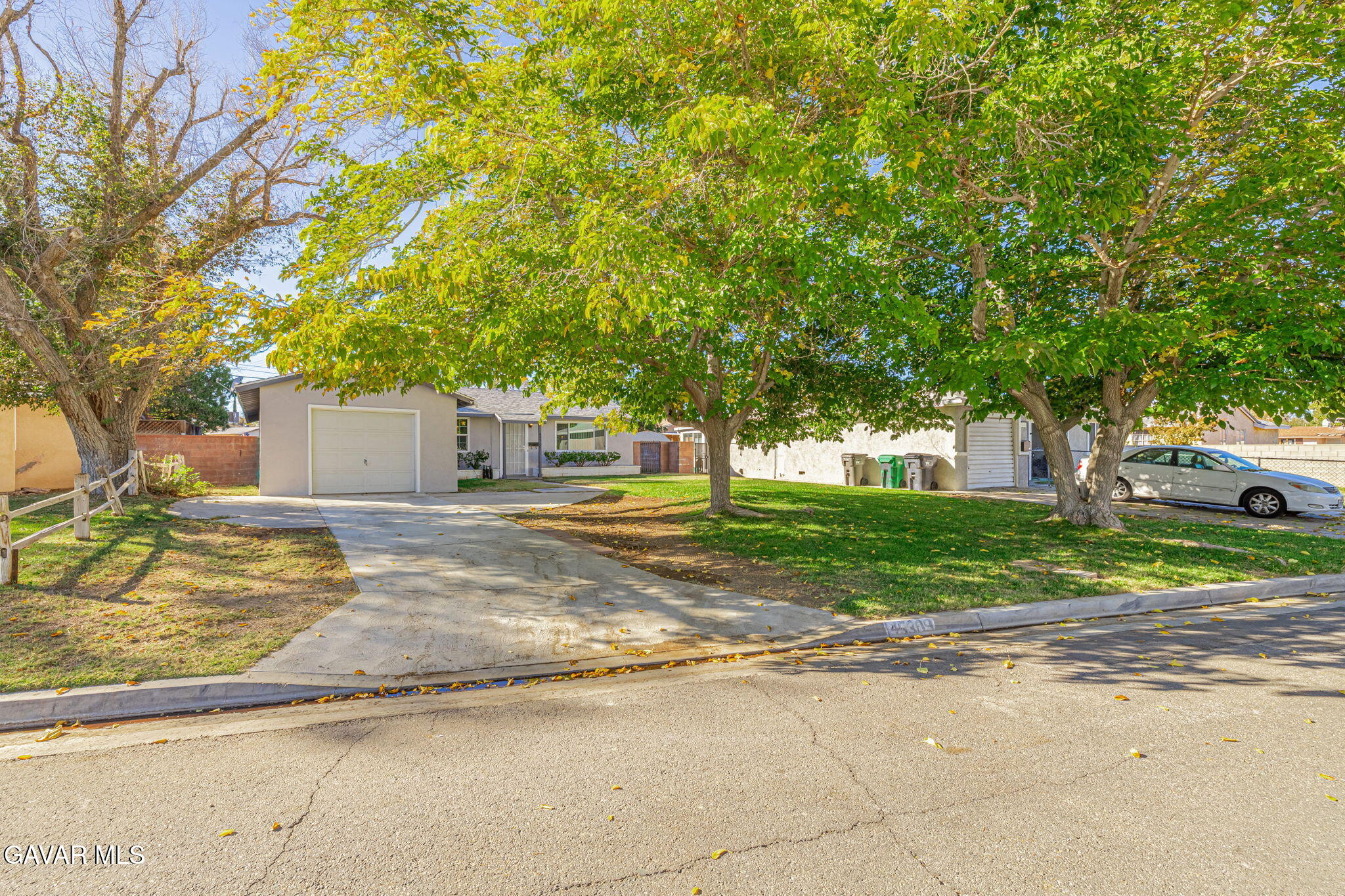 45309 Newtree Avenue Lancaster, CA 93534 - Photo 5 of 35 a view of a house with a yard and large tree