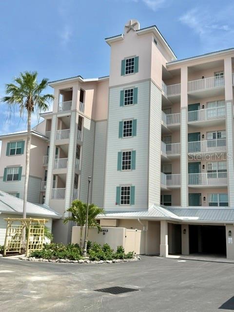13413 Gasparilla Road, Unit 304 Placida, FL 33946 - Photo 3 of 28 a front view of a building with a garden