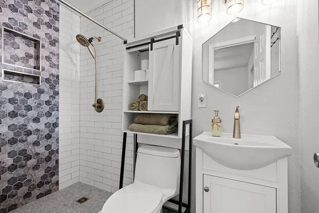 a bathroom with a sink toilet and shower