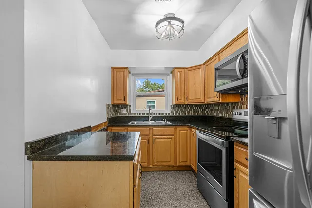 a kitchen with a sink a stove and cabinets