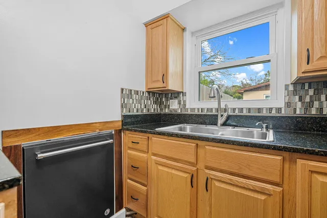 a kitchen with a sink and a window