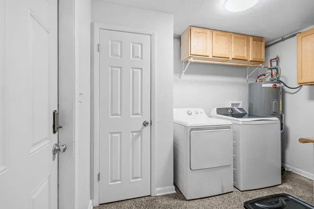 a view of storage and utility room with washer and dryer