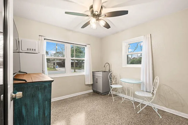 a view of a room with a window and furniture