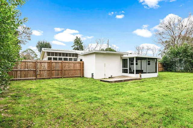 a view of a house with backyard space and garden