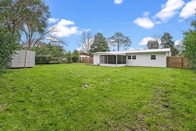 a view of a house with backyard porch and garden