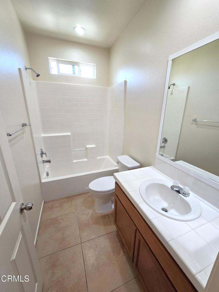 3319 North Ventura Road Oxnard, CA 93036 - Photo 9 of 25 a bathroom with a sink a toilet and a mirror
