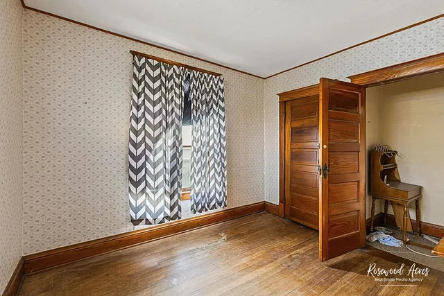 a view of front door with wooden floor and a rug