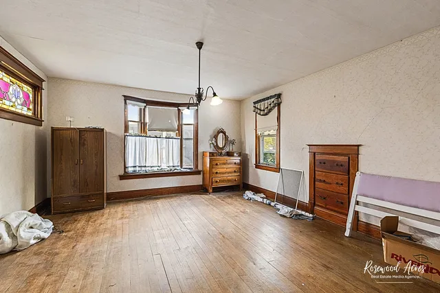a view of livingroom with furniture wooden floor cabinet and mirror
