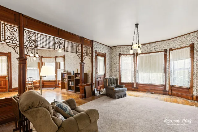 a living room with furniture and large windows