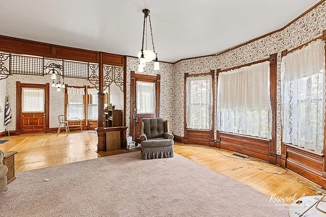a living room with furniture and floor to ceiling windows