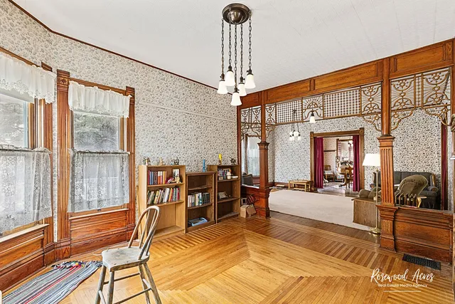 a living room with furniture a large window and chandelier
