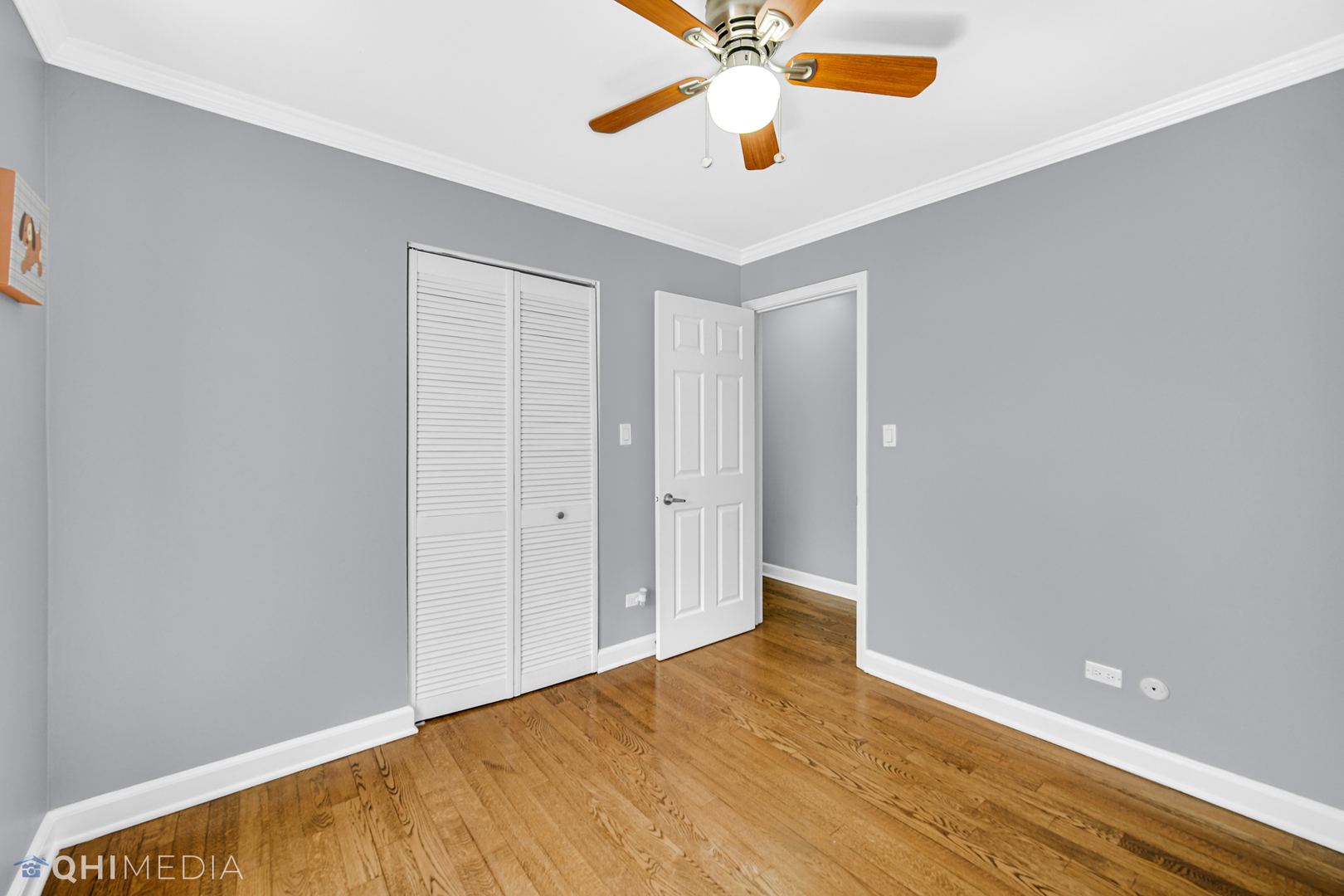 232 Inverrary Lane, Unit 232 Deerfield, IL 60015 - Photo 21 of 27 an empty room with a ceiling fan and wooden floor