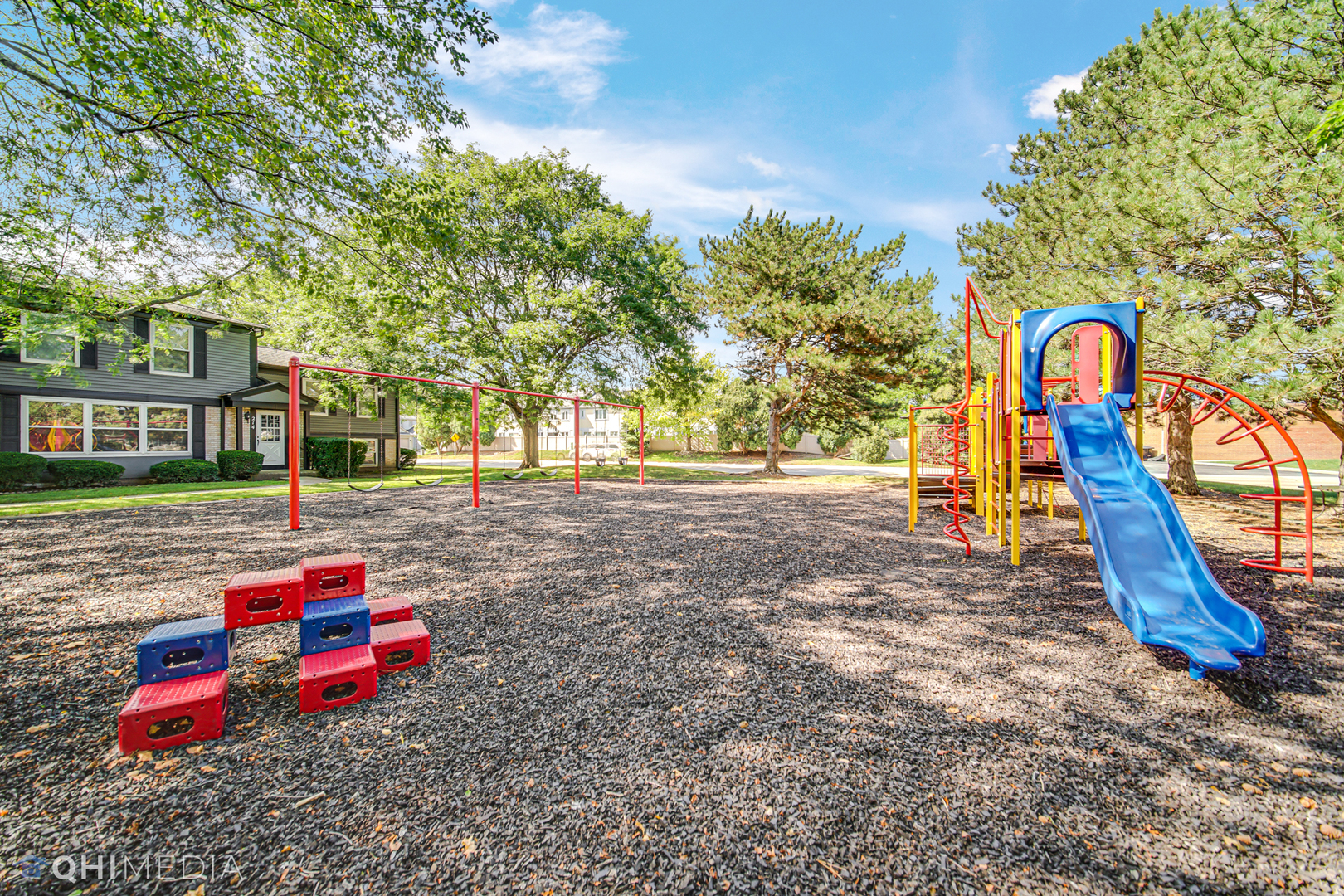 232 Inverrary Lane, Unit 232 Deerfield, IL 60015 - Photo 26 of 27 a backyard of a house with childrens swings and slides
