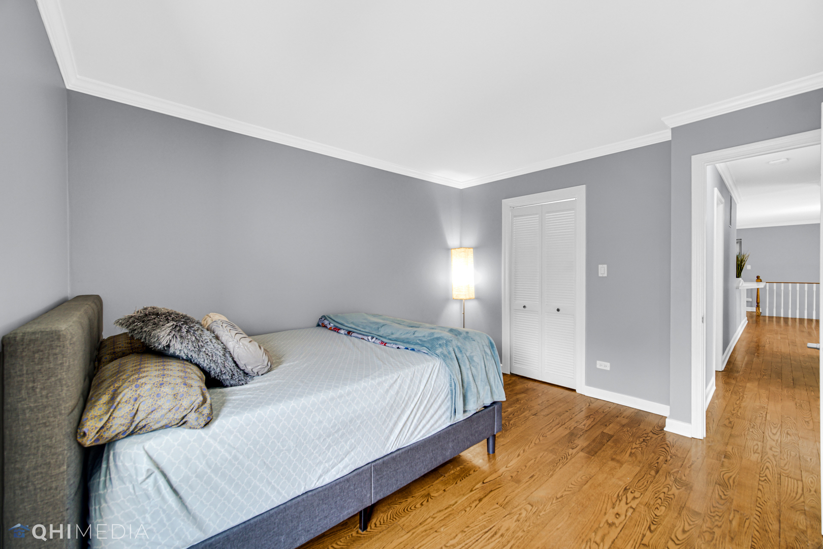 232 Inverrary Lane, Unit 232 Deerfield, IL 60015 - Photo 7 of 27 a bedroom with a bed and wooden floor