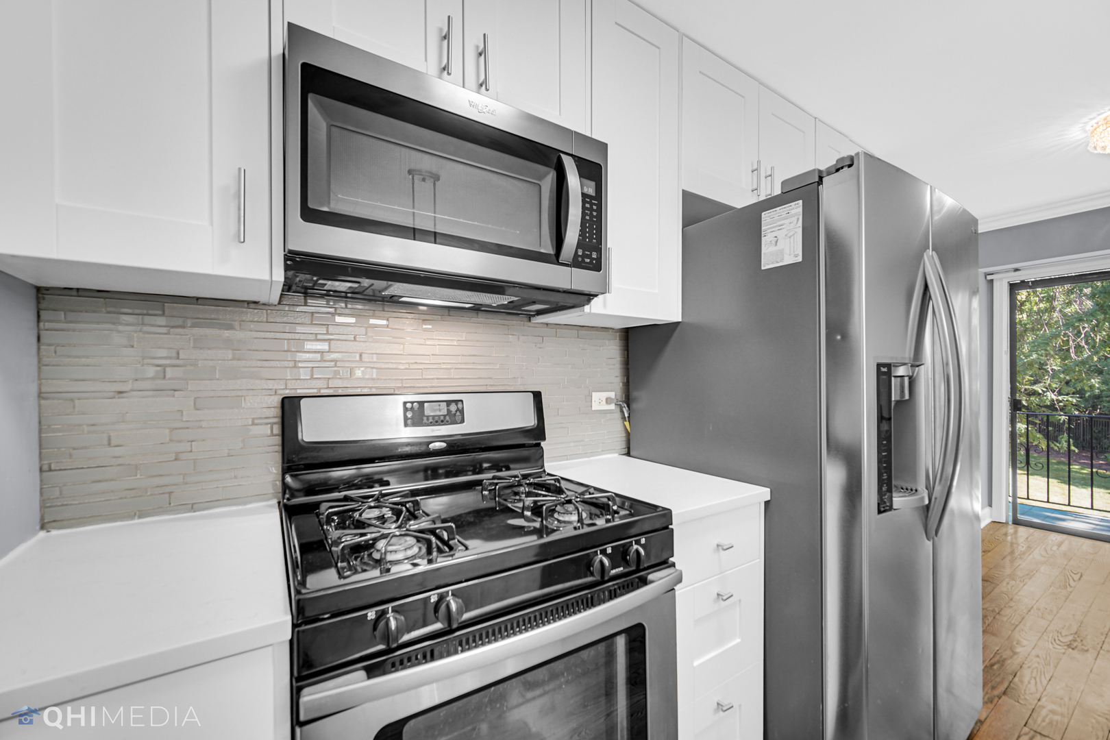232 Inverrary Lane, Unit 232 Deerfield, IL 60015 - Photo 10 of 27 a kitchen with stainless steel appliances white cabinets and a stove top oven