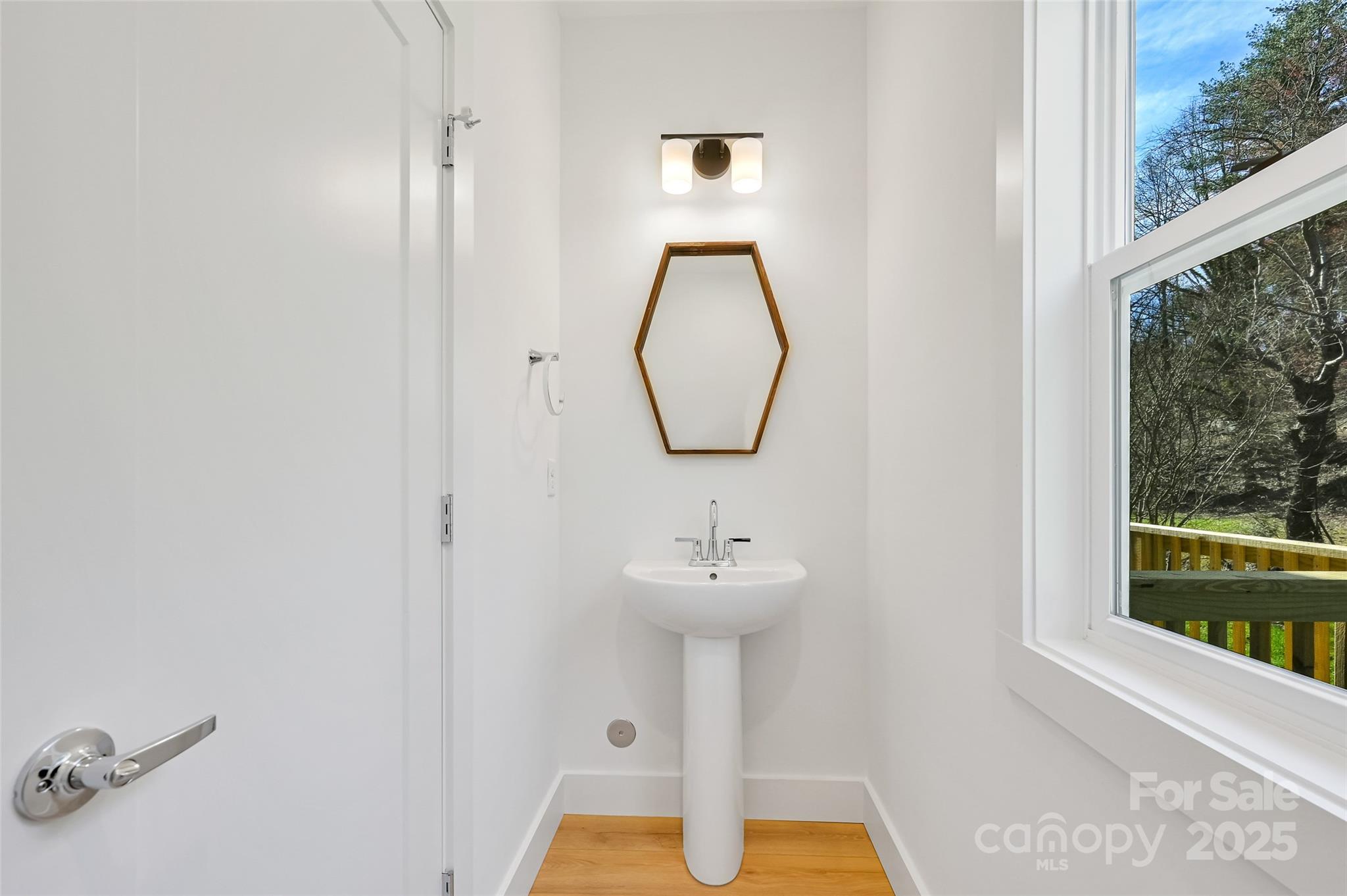 2 Cub Road Asheville, NC 28806 - Photo 12 of 24 a bathroom with a sink a mirror and a window