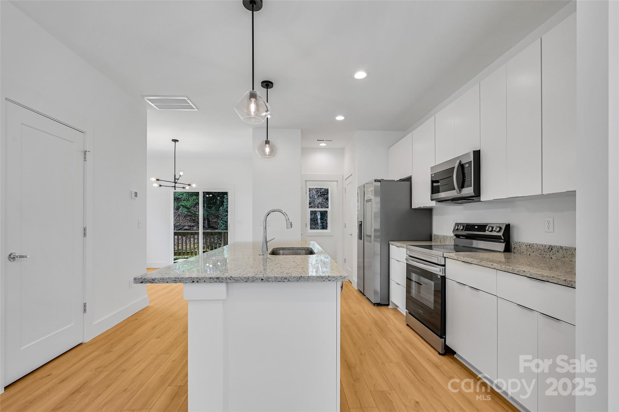 2 Cub Road Asheville, NC 28806 - Photo 7 of 24 a kitchen with stainless steel appliances granite countertop a sink a stove and a refrigerator