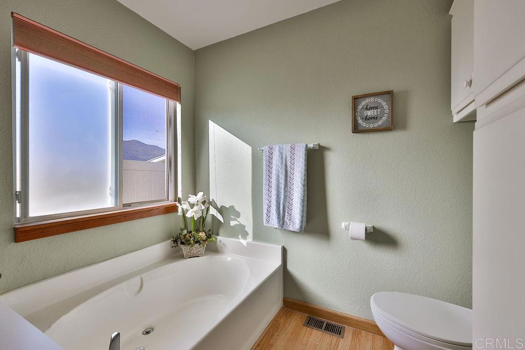 15935 Spring Oaks Road, Unit SPC 169 El Cajon, CA 92021 - Photo 11 of 24 a bath tub sitting next to a white toilet