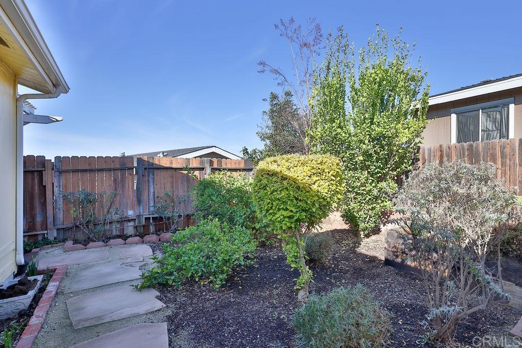 15935 Spring Oaks Road, Unit SPC 169 El Cajon, CA 92021 - Photo 14 of 24 a view of a garden with a building in the background