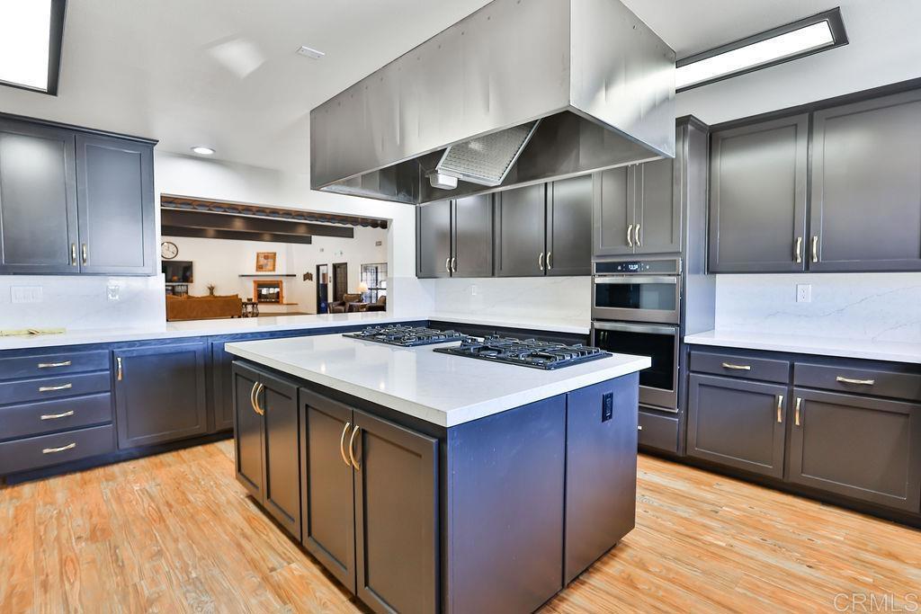 15935 Spring Oaks Road, Unit SPC 169 El Cajon, CA 92021 - Photo 22 of 24 a kitchen with stainless steel appliances granite countertop a stove a sink and a refrigerator