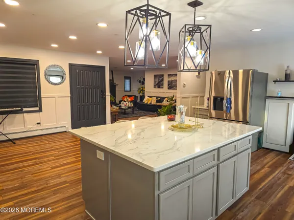 a kitchen with stainless steel appliances kitchen island a chandelier