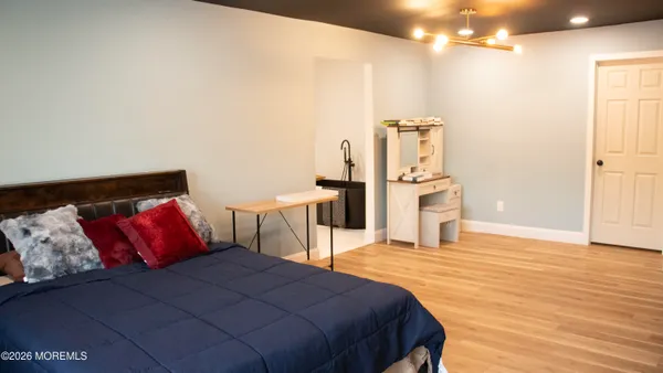 a bedroom with a bed and a chandelier