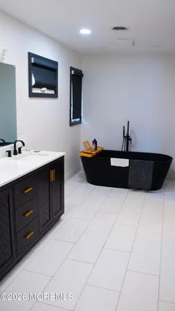 a living room with a dresser and a flat screen tv