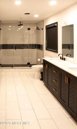 a bathroom with a sink a large mirror and a bathtub