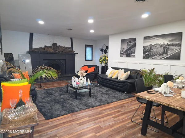 a living room with furniture and wooden floor