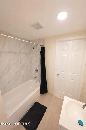 a bathroom with a bathtub and a shower