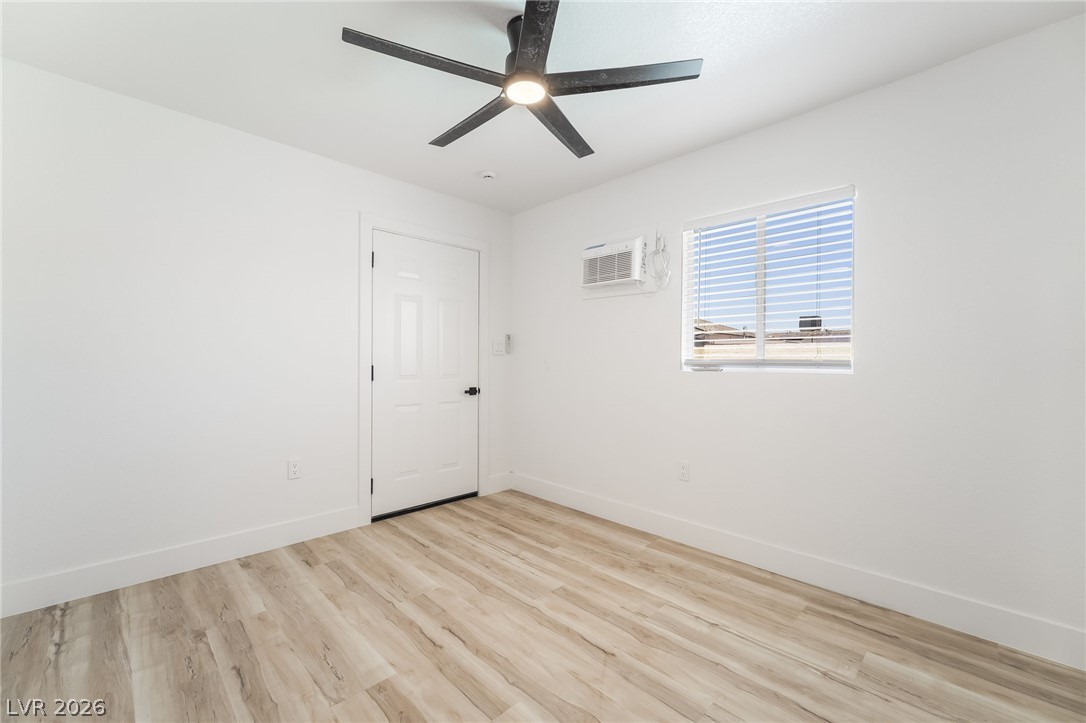 39 Lowery Street Henderson, NV 89015 - Photo 29 of 40 A streamlined bedroom space features light wood-look flooring and a contemporary ceiling fan.