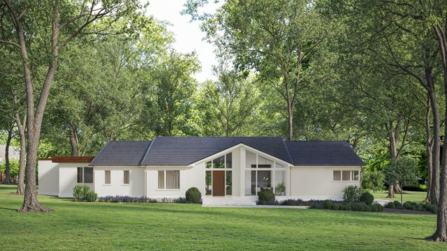 a front view of a house with a garden