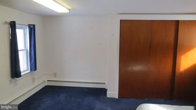 a kitchen with granite countertop wooden cabinets a refrigerator and a sink