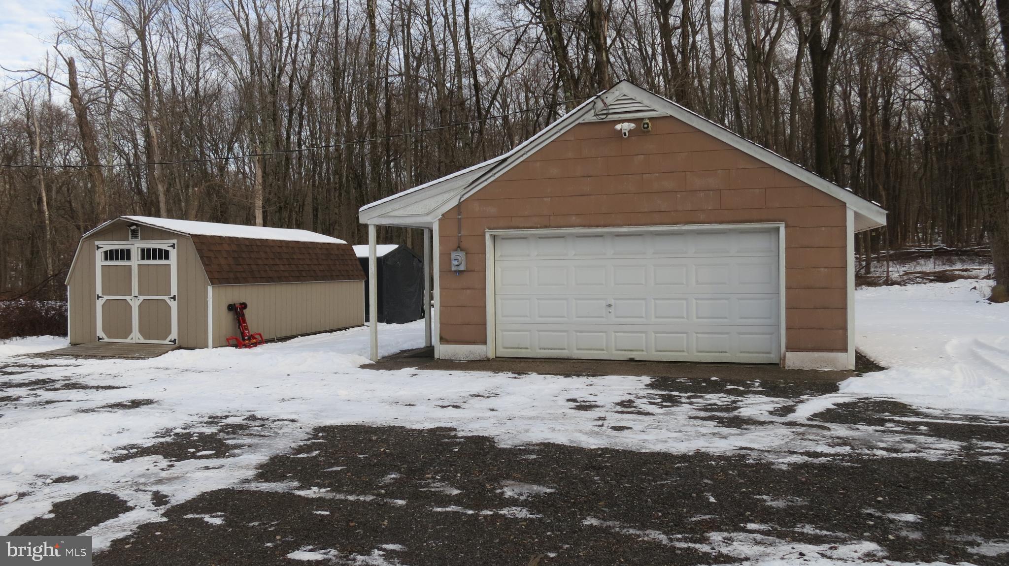 99 Lindbergh Road Hopewell, NJ 08525 - Photo 60 of 64 Charming garage nestled in a snowy landscape.