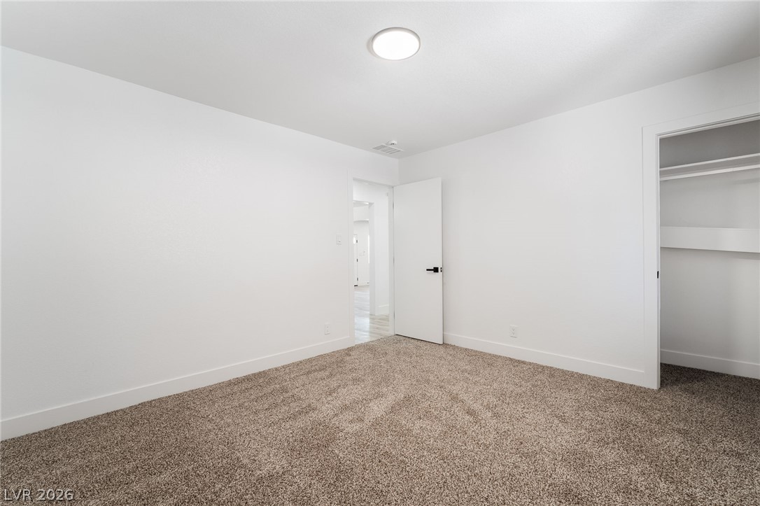 39 Lowery Street Henderson, NV 89015 - Photo 20 of 40 A spacious and inviting area, perfect for personalization, features new carpet and crisp white walls.
