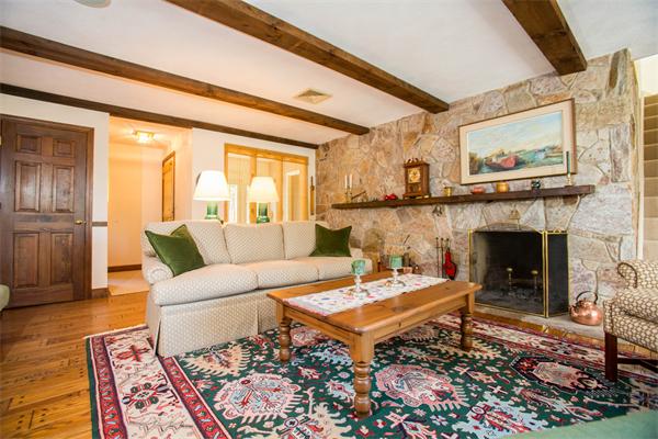 85 Myles Standish Road Weston, MA 02493 - Photo 21 of 28 a living room with furniture a fireplace and a large window