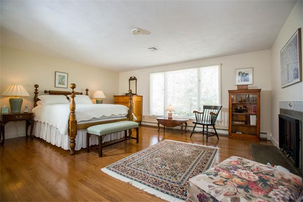 85 Myles Standish Road Weston, MA 02493 - Photo 24 of 28 a bedroom with furniture and a fireplace